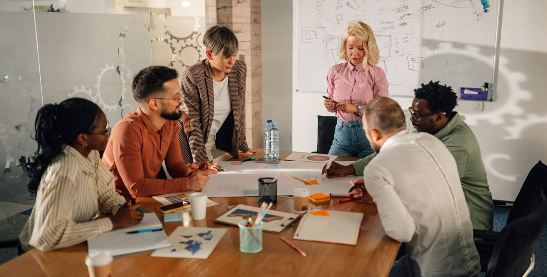 Colleagues review digital agency alternatives at meeting table